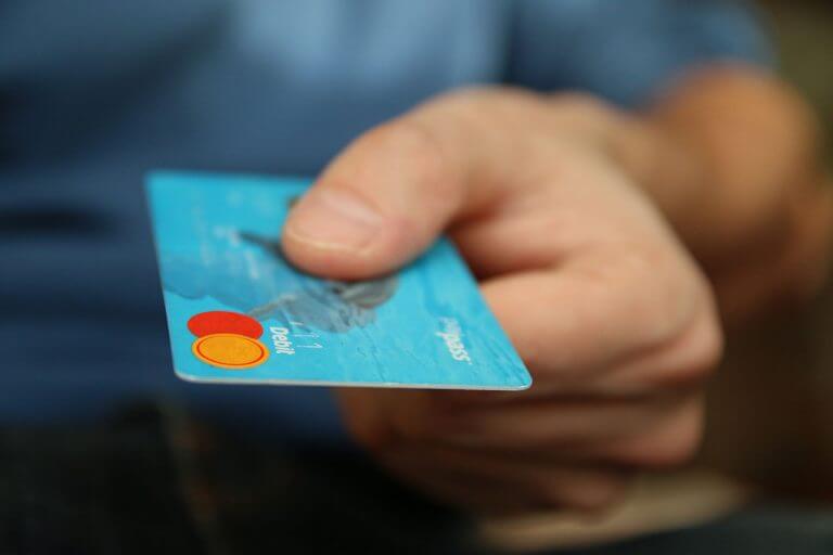 Man holding a debit card.