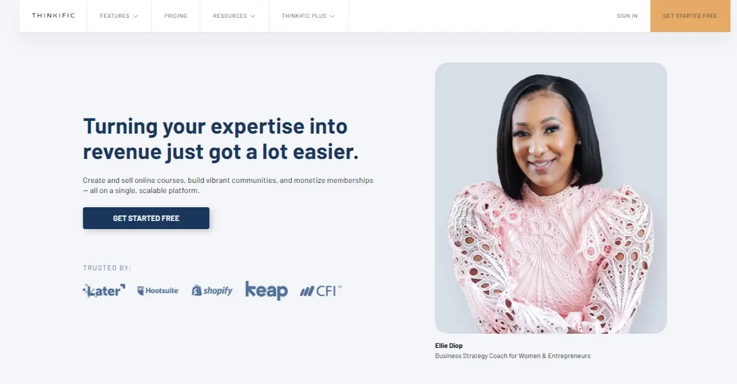 A screenshot from Thinkific’s website with a black woman on the right, some logos of training academies, and a tag line for Turning your expertise into revenue just got a lot easier.