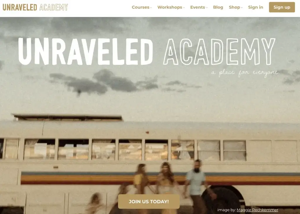 a screenshot of Unraveled Academy's landing page showing a group of people holding hands and walking in front of an RV