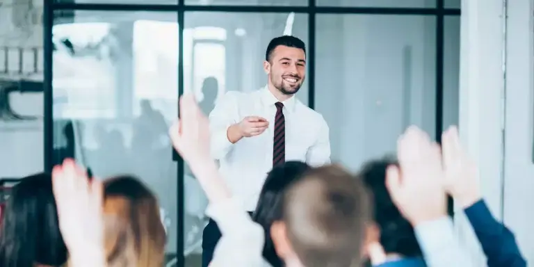 man wearing tie teaching a group of people