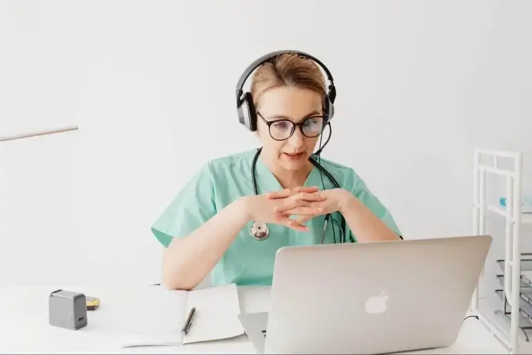 A doctor is educating patients online through her computer.